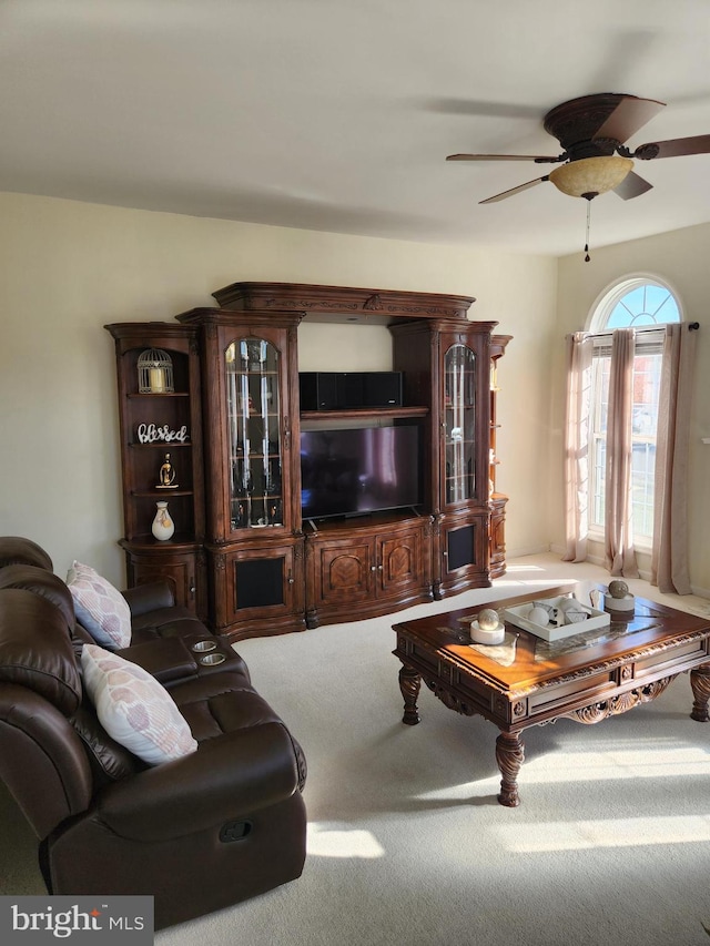 carpeted living room featuring ceiling fan