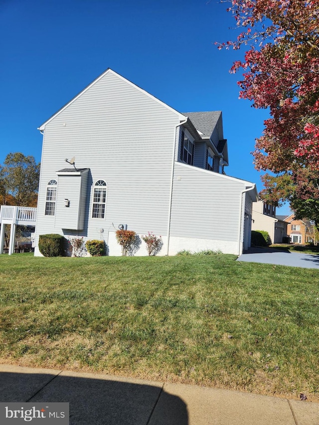 view of side of home with a lawn