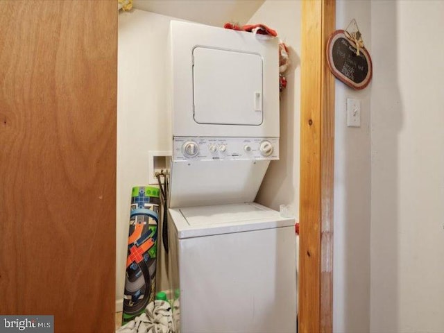 laundry area featuring stacked washer / dryer