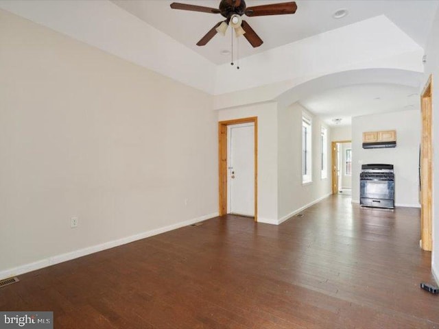 unfurnished living room with dark wood-type flooring and ceiling fan