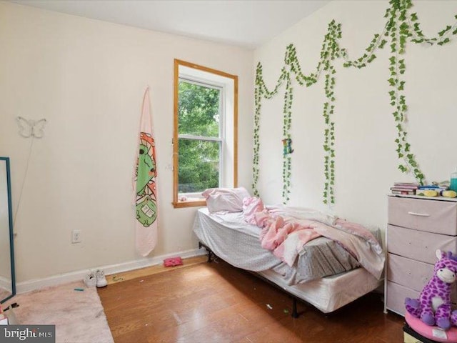 bedroom featuring hardwood / wood-style flooring and vaulted ceiling