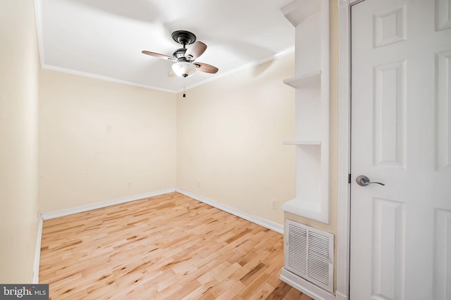 spare room featuring ceiling fan, wood-type flooring, and ornamental molding