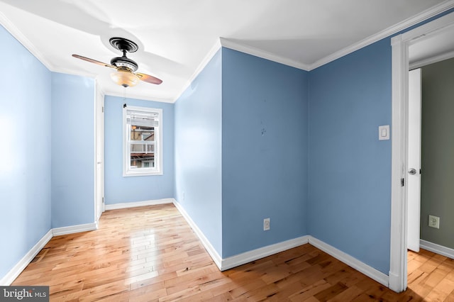 empty room with ceiling fan, light hardwood / wood-style floors, and ornamental molding