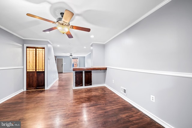 unfurnished living room with crown molding, ceiling fan, and dark hardwood / wood-style floors