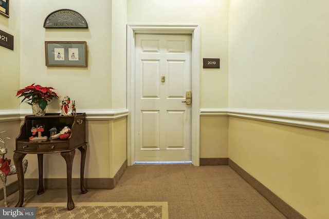 doorway with carpet floors