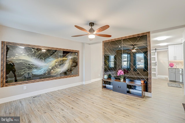 interior space with light wood-type flooring and ceiling fan