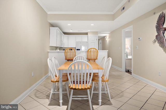 tiled dining area featuring ornamental molding