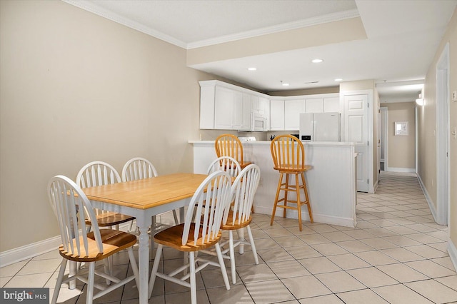 tiled dining space featuring crown molding