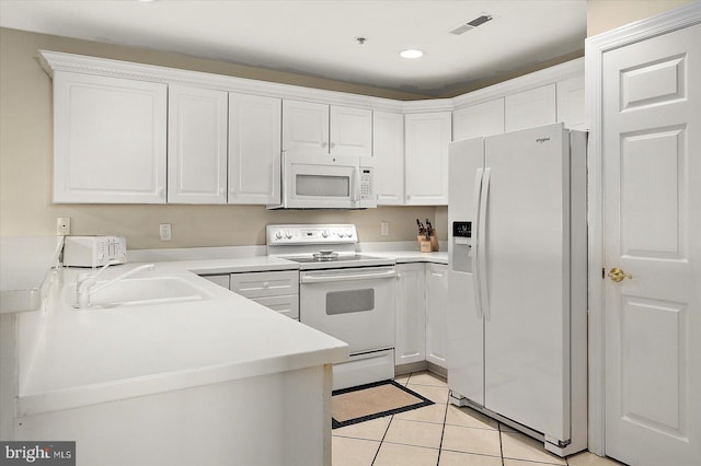 kitchen featuring white cabinetry, sink, light tile patterned floors, and white appliances