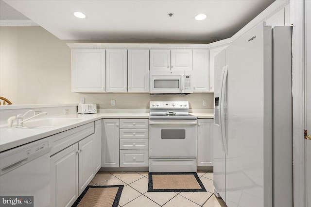 kitchen featuring white cabinets, light tile patterned floors, white appliances, and sink