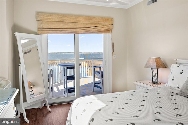 bedroom featuring access to exterior, crown molding, a water view, and dark hardwood / wood-style floors