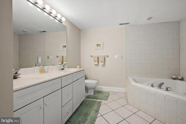 bathroom featuring tile patterned flooring, vanity, toilet, and tiled tub