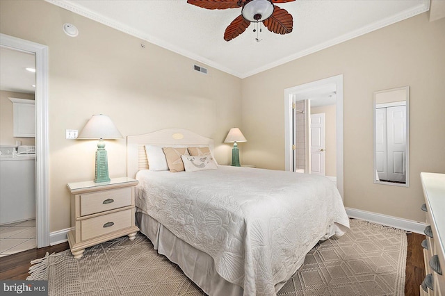 bedroom with ceiling fan, ornamental molding, dark wood-type flooring, and connected bathroom