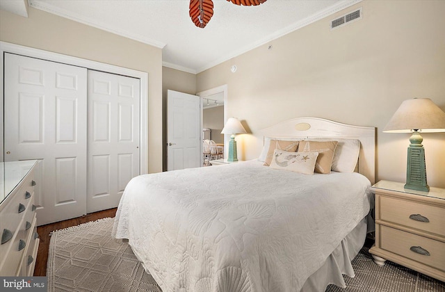 bedroom featuring dark hardwood / wood-style floors, a closet, crown molding, and ceiling fan