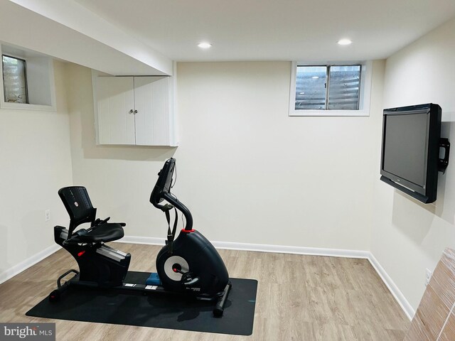 exercise room featuring light wood-type flooring