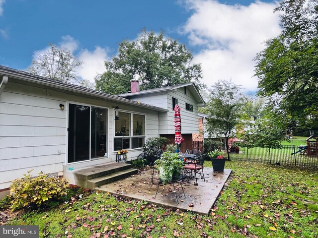 rear view of property with a patio area and a lawn