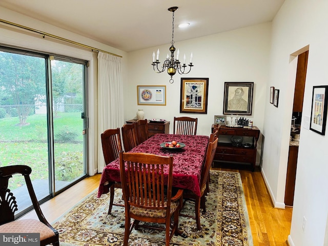 dining area featuring light hardwood / wood-style floors and a chandelier