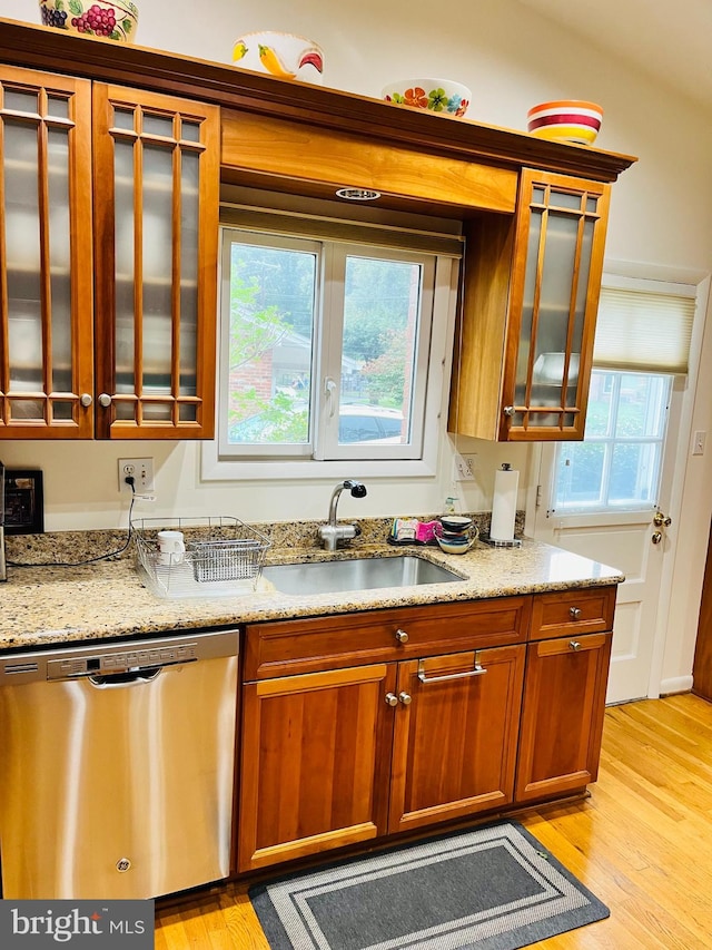 kitchen featuring dishwasher, a healthy amount of sunlight, light wood-type flooring, and sink