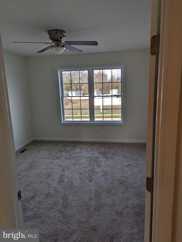 spare room featuring carpet flooring and ceiling fan