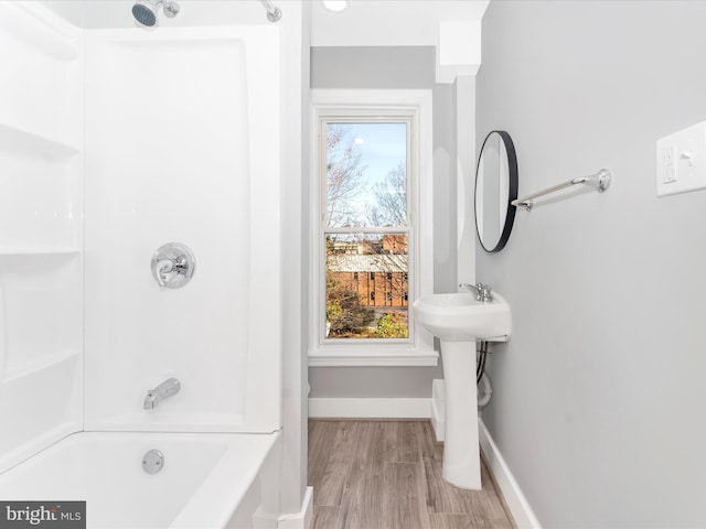 bathroom with plenty of natural light, wood-type flooring, sink, and shower / bathtub combination