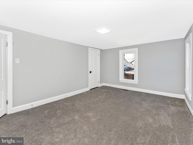 empty room with dark carpet