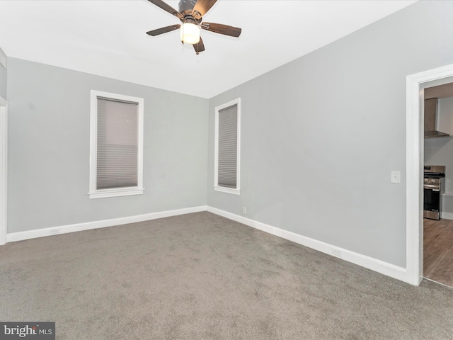 spare room featuring carpet and ceiling fan