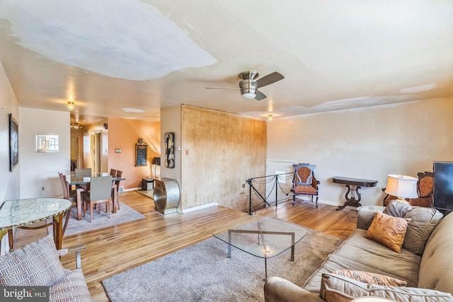 living room featuring light hardwood / wood-style flooring and ceiling fan