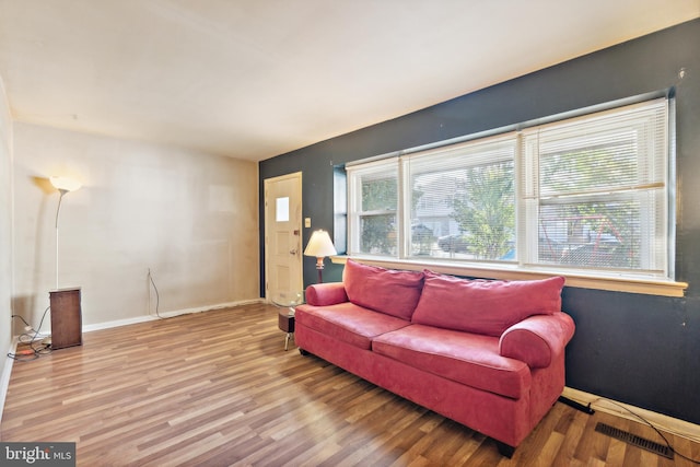 living room with a healthy amount of sunlight and hardwood / wood-style flooring