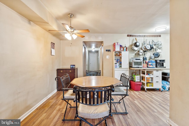 dining area featuring light hardwood / wood-style flooring and ceiling fan