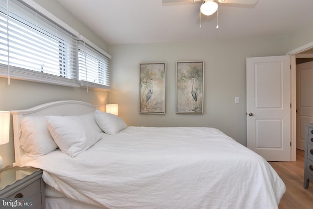 bedroom with light hardwood / wood-style floors and ceiling fan