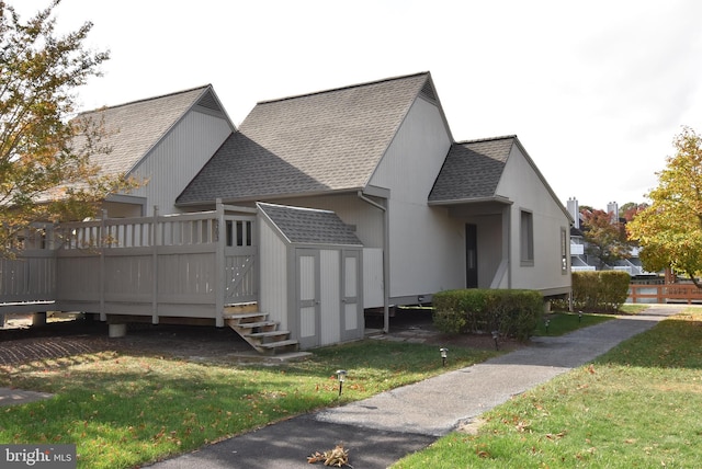 view of property exterior with a wooden deck and a yard