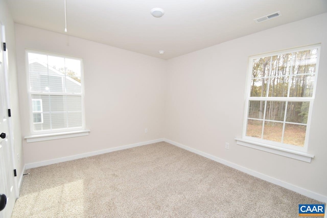 unfurnished room featuring light colored carpet