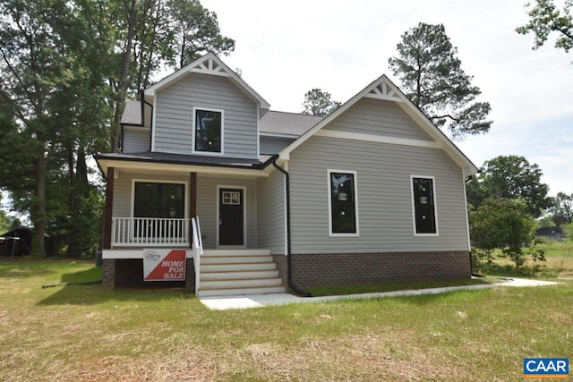 craftsman inspired home with a porch and a front yard