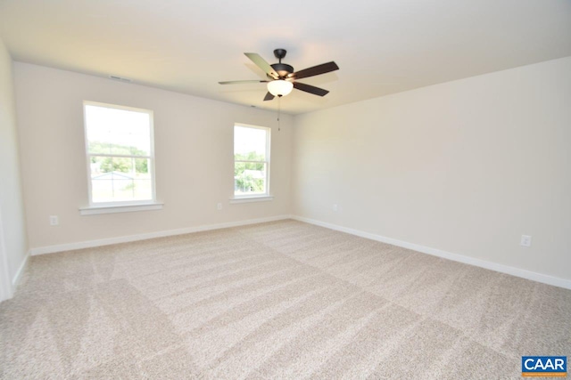 unfurnished room with ceiling fan and light colored carpet