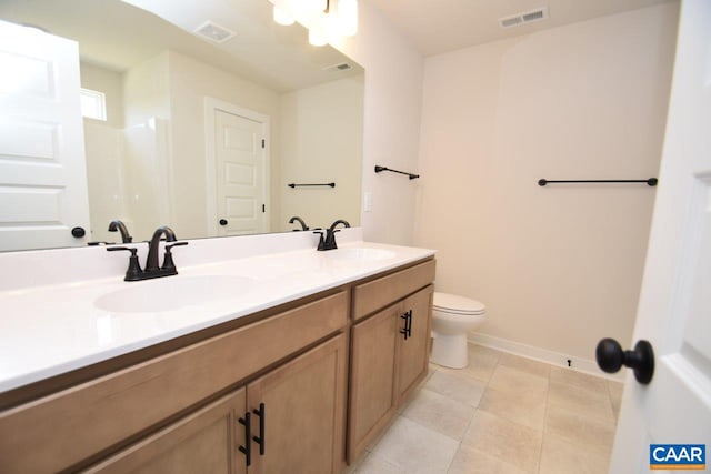 bathroom with tile patterned floors, vanity, and toilet