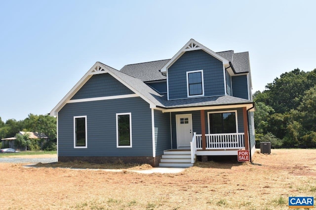 view of front of home with covered porch and central AC