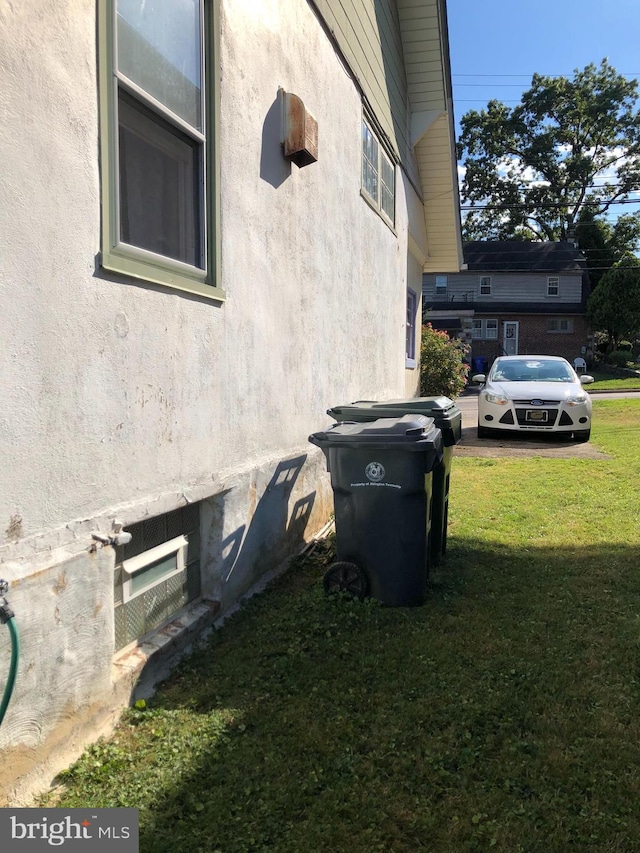 view of side of property with a lawn