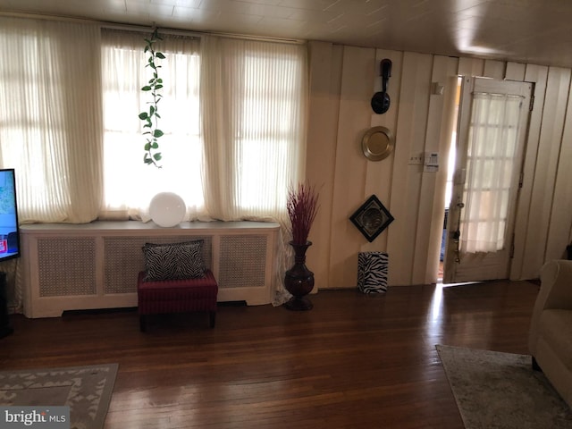 entrance foyer with dark hardwood / wood-style floors and radiator