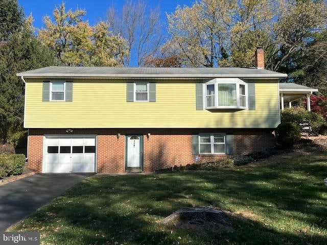 view of front of house with a garage and a front lawn