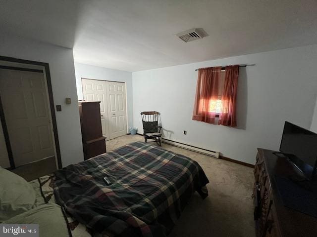 bedroom featuring carpet flooring and a baseboard heating unit