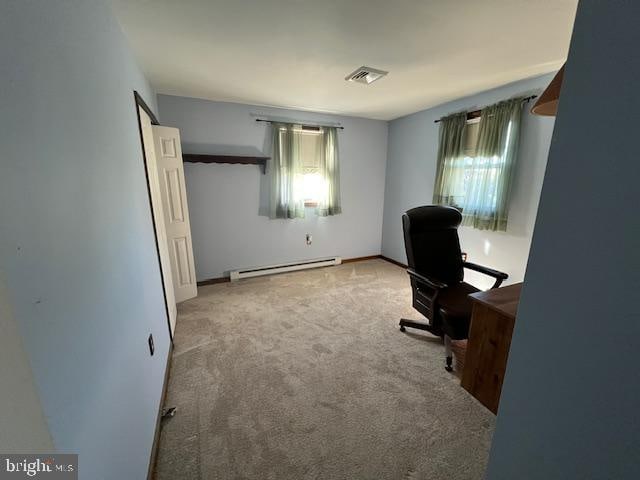 office featuring light carpet and baseboard heating