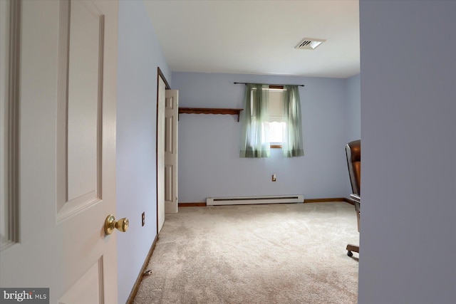 carpeted bedroom featuring a baseboard heating unit