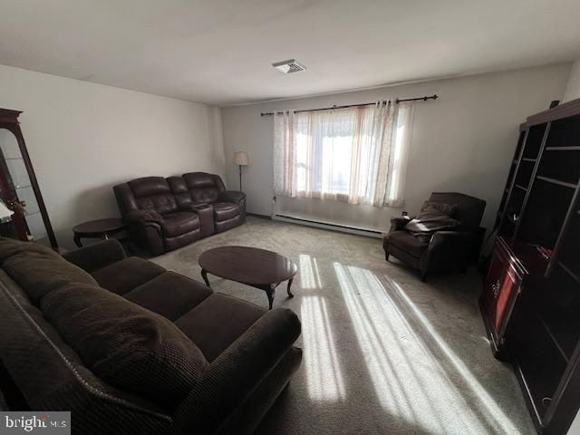 carpeted living room featuring a baseboard radiator