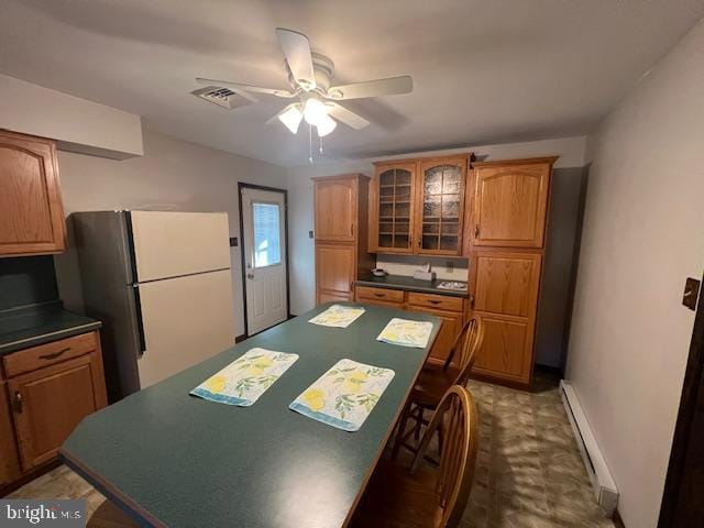 kitchen with baseboard heating, ceiling fan, and white fridge