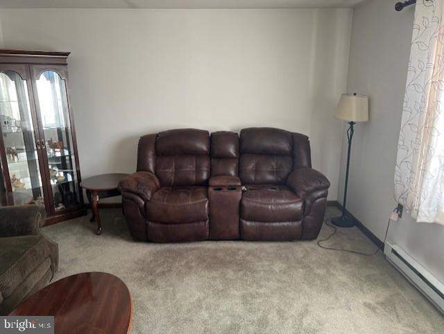 living room featuring light colored carpet and a baseboard radiator