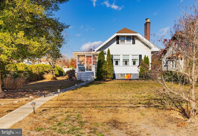 exterior space with a sunroom and a yard