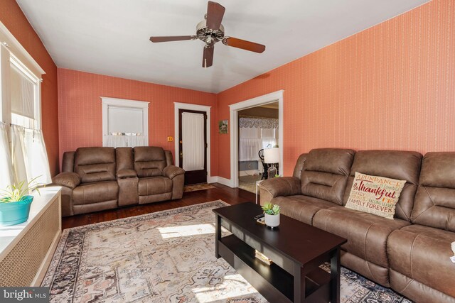 living room with hardwood / wood-style flooring and ceiling fan