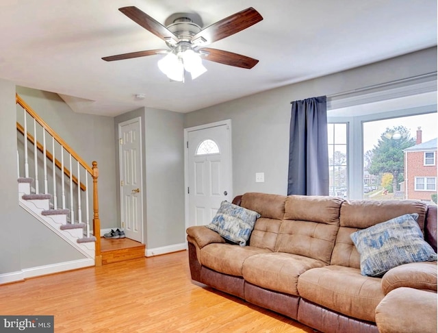 living room with ceiling fan and light hardwood / wood-style flooring