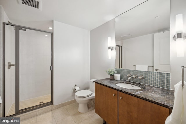 bathroom featuring tasteful backsplash, vanity, tile patterned floors, and walk in shower