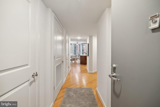 corridor with light hardwood / wood-style floors